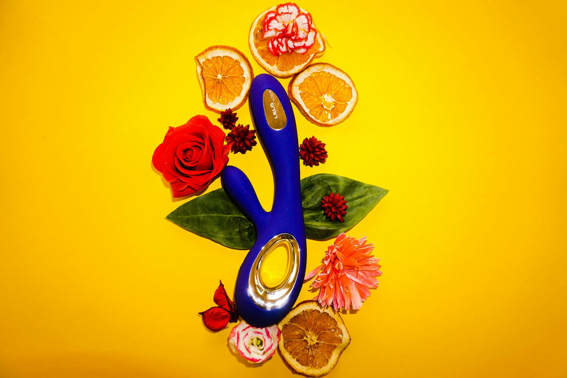 A blue silicone sex toy held in hand against a solid purple background, promoting self-love and sexuality